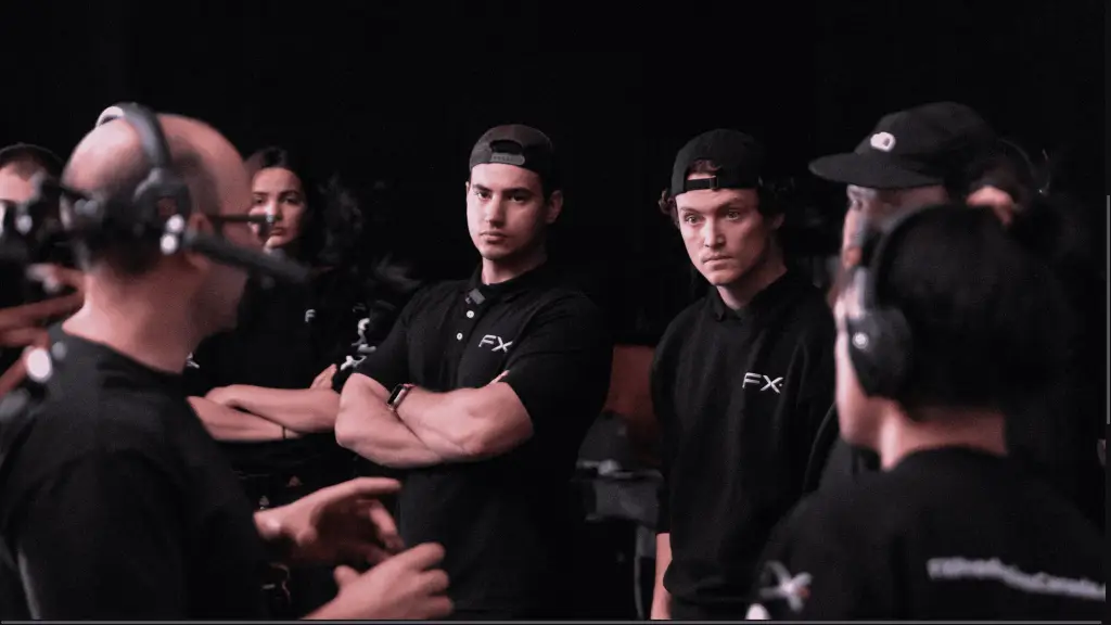 A group of men wearing black shirts and hats, standing together.
